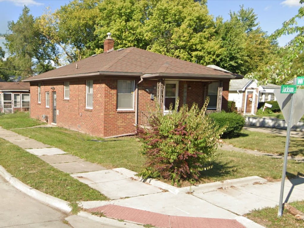 bungalow-style home featuring a front yard