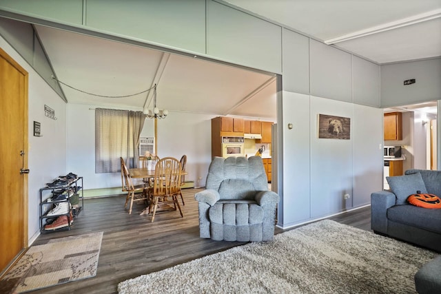 living room featuring a notable chandelier and dark hardwood / wood-style flooring