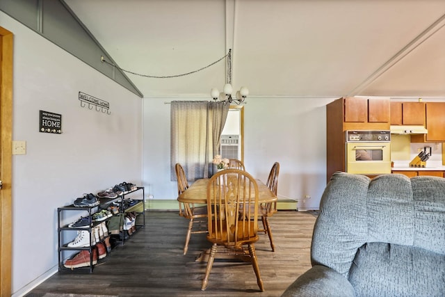 dining space featuring hardwood / wood-style flooring, a baseboard radiator, and an inviting chandelier