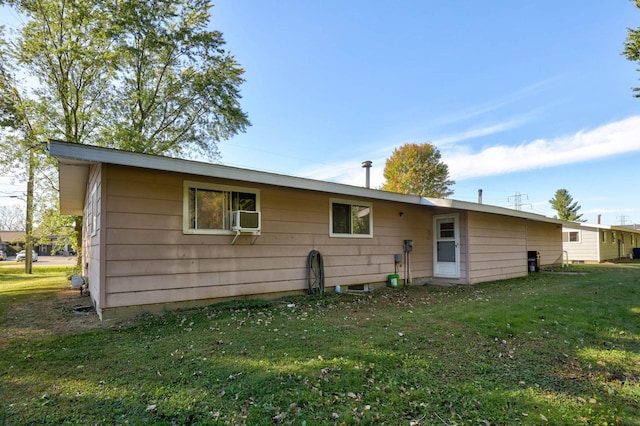 back of property with a lawn and cooling unit