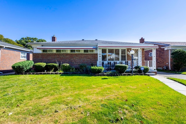 ranch-style home featuring a front yard