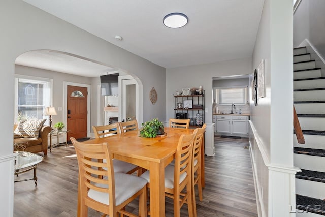 dining space featuring hardwood / wood-style flooring, sink, and a wealth of natural light