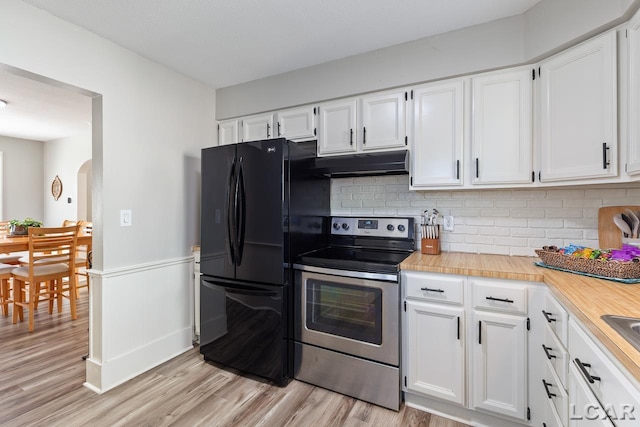 kitchen with white cabinets, backsplash, stainless steel appliances, and light hardwood / wood-style floors