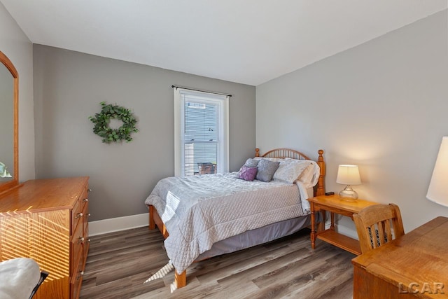 bedroom with dark hardwood / wood-style flooring