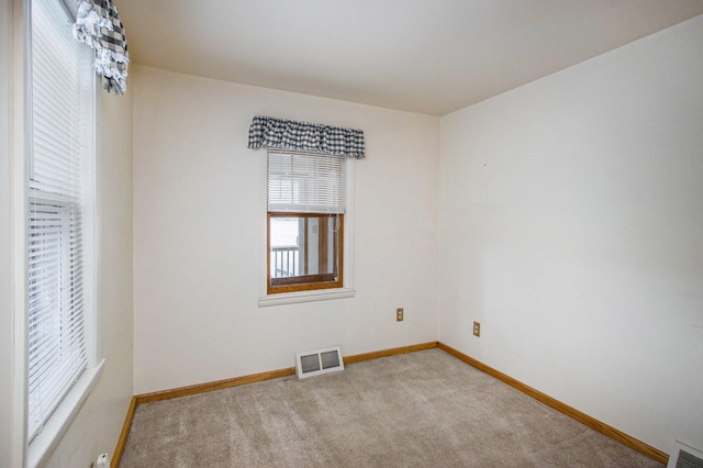 empty room featuring light colored carpet