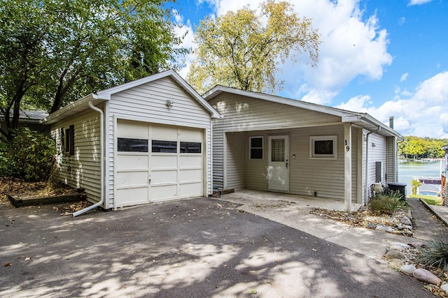 single story home featuring a water view and a garage