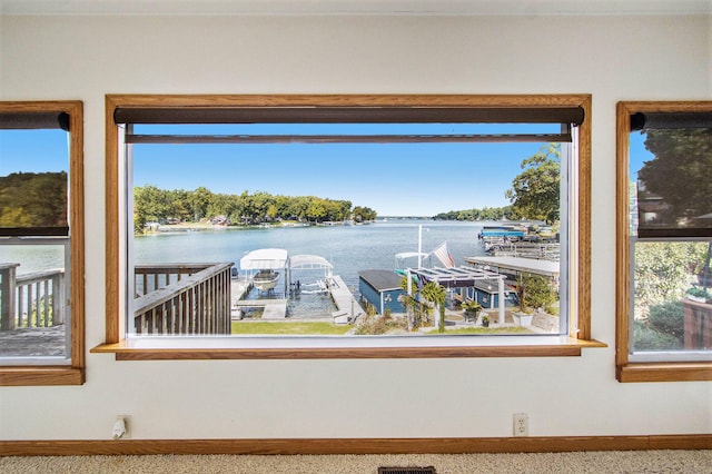 interior space featuring carpet flooring and a water view