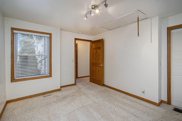 unfurnished bedroom featuring light colored carpet and a closet