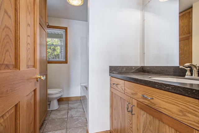 bathroom with tile patterned flooring, vanity, and toilet