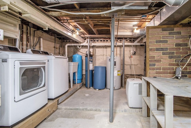 basement with washing machine and dryer and electric water heater