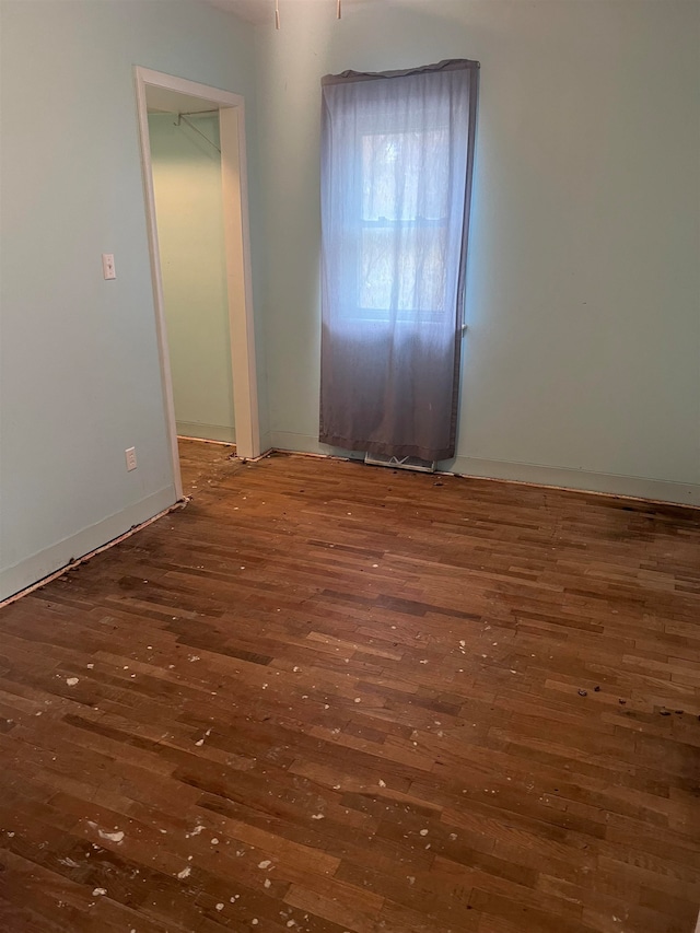 unfurnished room with dark hardwood / wood-style floors