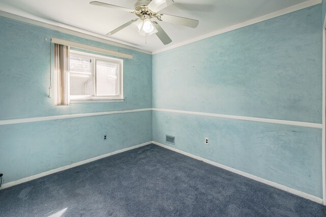 carpeted spare room featuring ceiling fan and crown molding