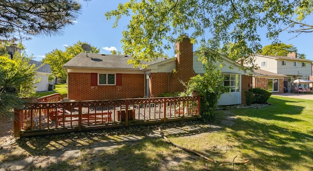 back of house with a lawn and a wooden deck