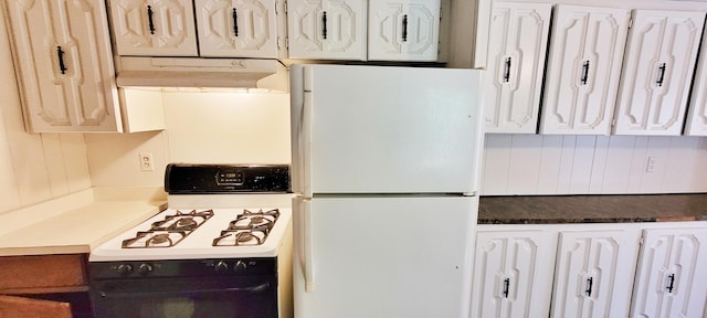 kitchen featuring white cabinets and white appliances