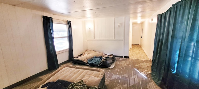 bedroom featuring wooden walls