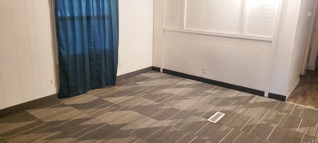 empty room featuring dark colored carpet