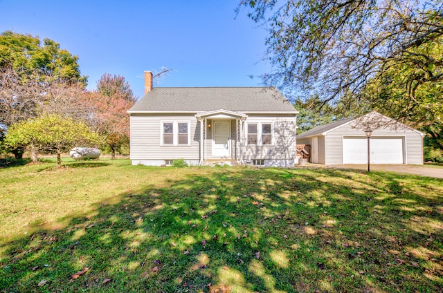 view of front of house featuring a garage, a front lawn, and an outdoor structure