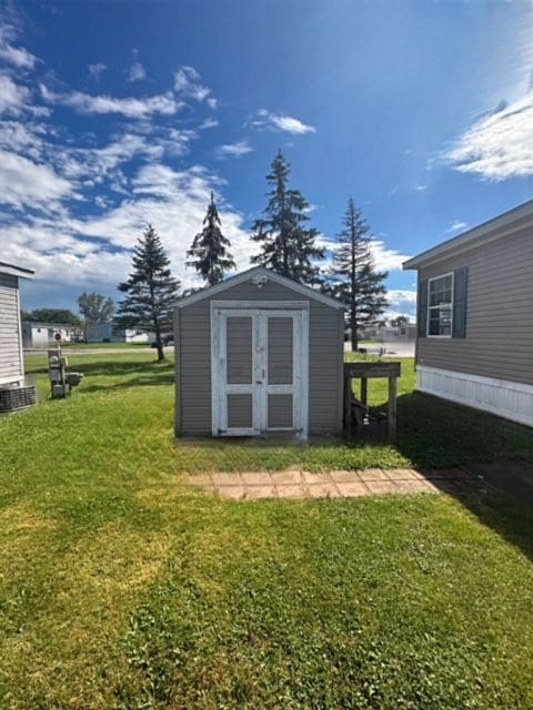 view of outbuilding featuring a yard