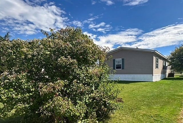 view of property exterior featuring a lawn