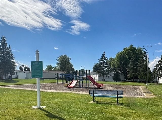 view of playground with a lawn