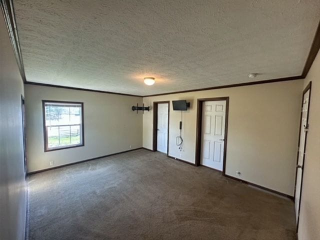 unfurnished bedroom with carpet flooring, crown molding, and a textured ceiling