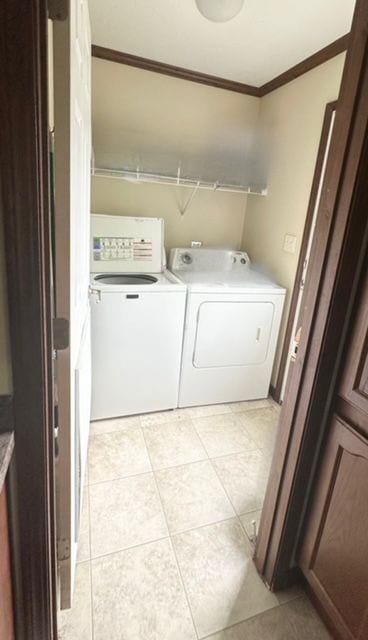 washroom with light tile patterned floors, ornamental molding, and independent washer and dryer