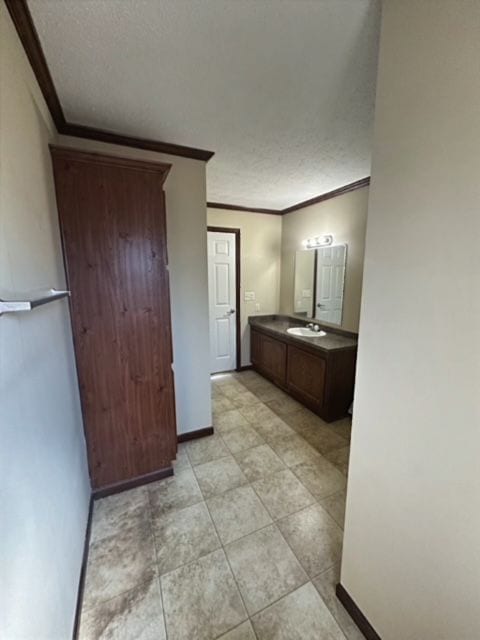 bathroom with crown molding and vanity