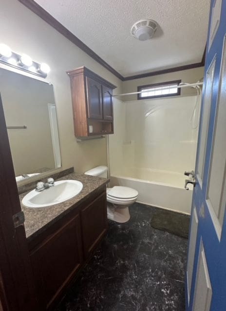 full bathroom with vanity, shower / bathing tub combination, a textured ceiling, and toilet