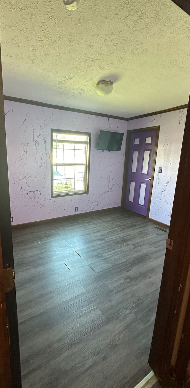 foyer featuring dark wood-type flooring and a textured ceiling