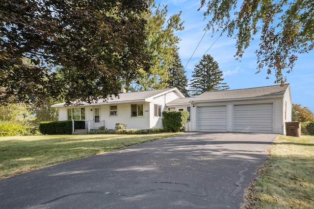 7080 Pine Island Dr NE, Comstock Park, MI 49321 - ranch-style house featuring a front yard and a garage
