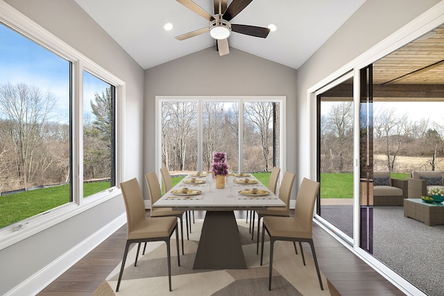 sunroom with ceiling fan and vaulted ceiling