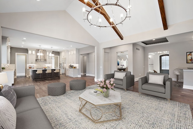 living room featuring beam ceiling, sink, high vaulted ceiling, dark hardwood / wood-style floors, and a chandelier