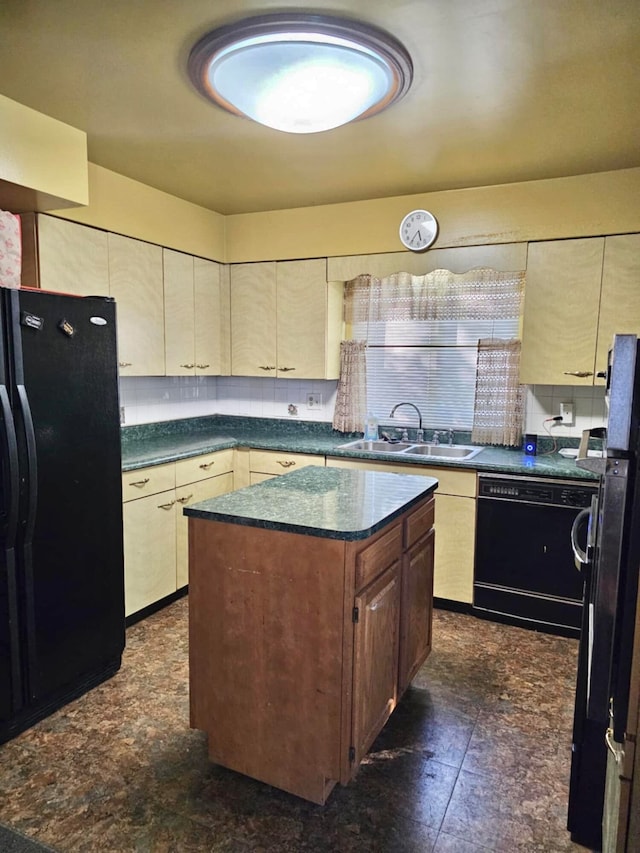 kitchen with sink, a center island, and black appliances