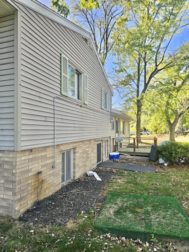 view of property exterior featuring a wooden deck