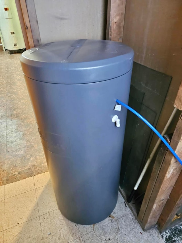 utility room featuring water heater