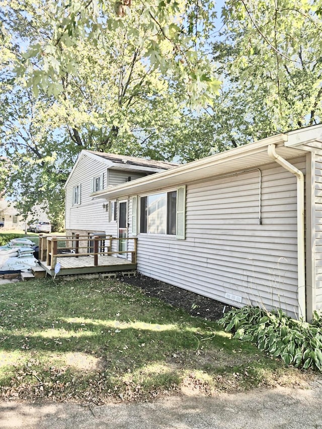 exterior space featuring a yard and a wooden deck