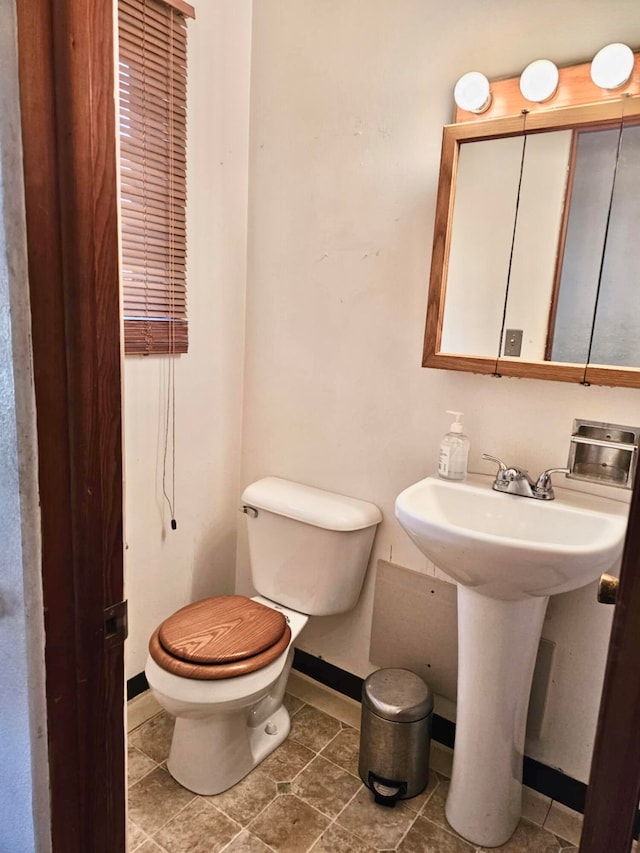 bathroom featuring tile patterned floors and toilet