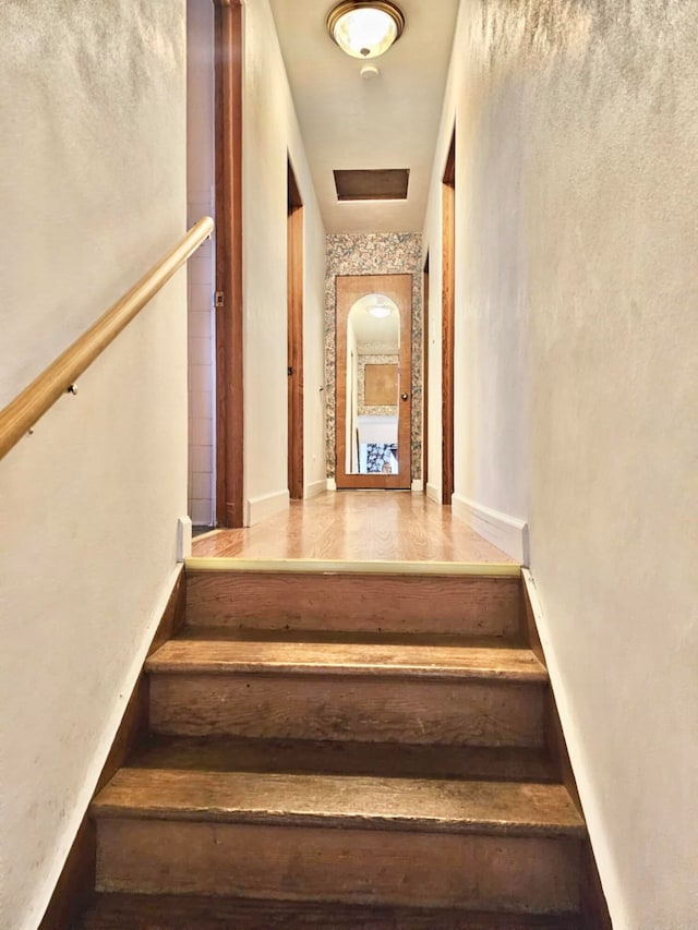 staircase featuring wood-type flooring