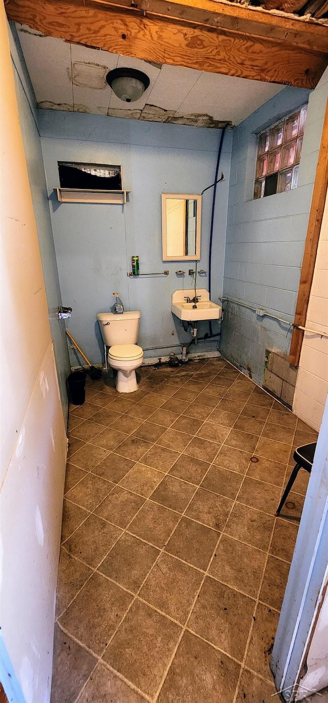 bathroom with tile patterned flooring, toilet, and sink