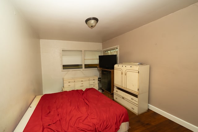 bedroom featuring dark hardwood / wood-style flooring