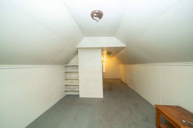 additional living space with light colored carpet and lofted ceiling