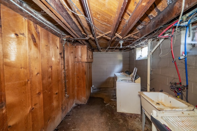 basement with separate washer and dryer and sink