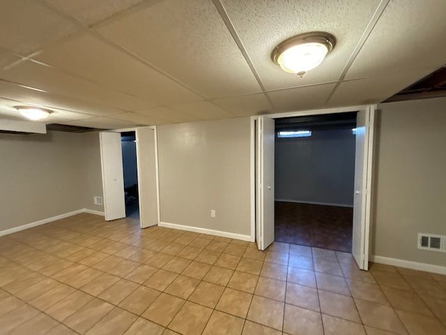 basement featuring a drop ceiling