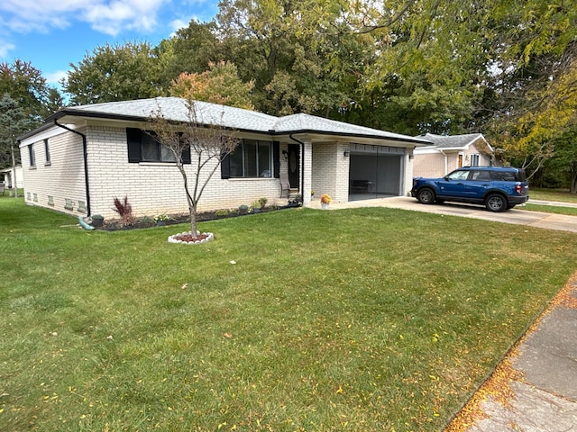 ranch-style house with a garage and a front lawn