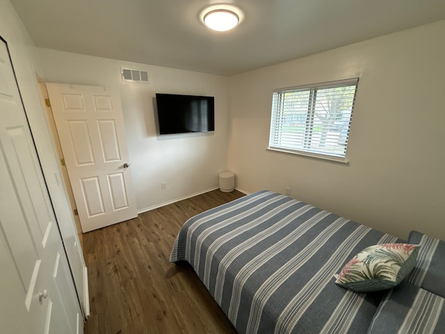 bedroom featuring dark wood-type flooring