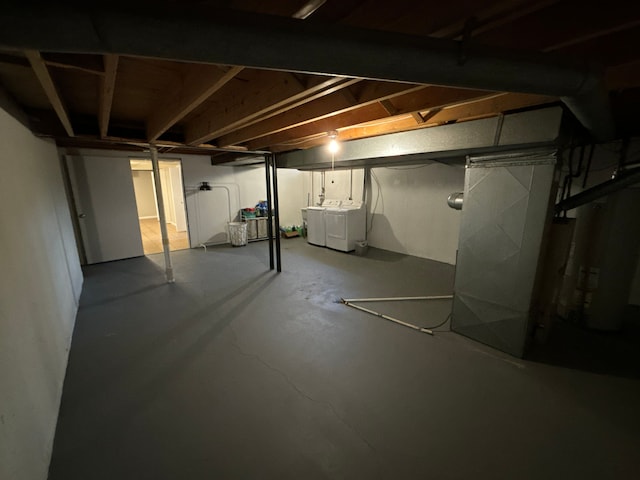 basement with gas water heater and separate washer and dryer