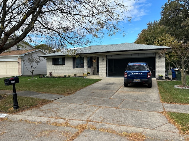 ranch-style house featuring a front yard and a garage