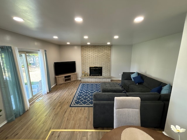 living room with hardwood / wood-style floors and a fireplace