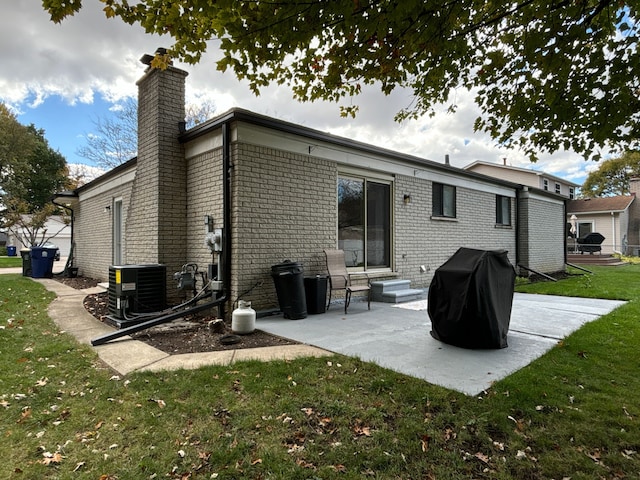 back of house featuring a yard, a patio, and central AC