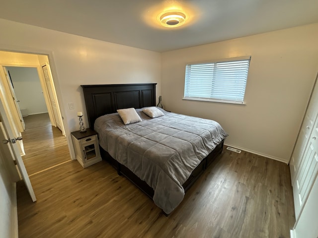 bedroom with a closet and dark wood-type flooring